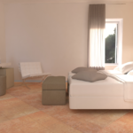 Ein einfacher Wohnraum mit einem weißen Bett und hellen Farbtönen.