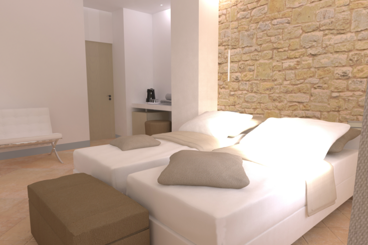 Innenansicht eines Zimmers mit Einzelbetten und Steinen Wänden.