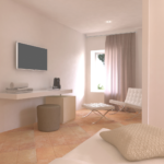 Innenansicht eines Schlafzimmers, einfach und gut beleuchtet, schlicht eingerichtet.