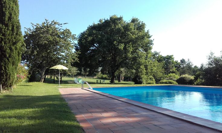 A quiet area with a pool, surrounded by trees and a gazebo. A perfect place to relax and refresh.