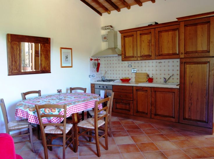 Traditional kitchen with wooden furniture and a tidy dining table.
