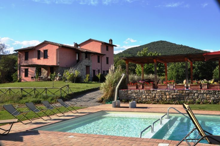 A peaceful structure with a pool, nestled among hills and green areas perfect for relaxation.