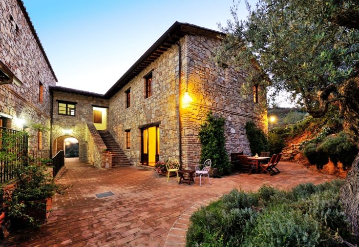Stone farmhouse set in a green area, with outdoor spaces and a pool for relaxation.