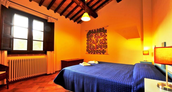 Bright and spacious room with a double bed and simple furnishings.