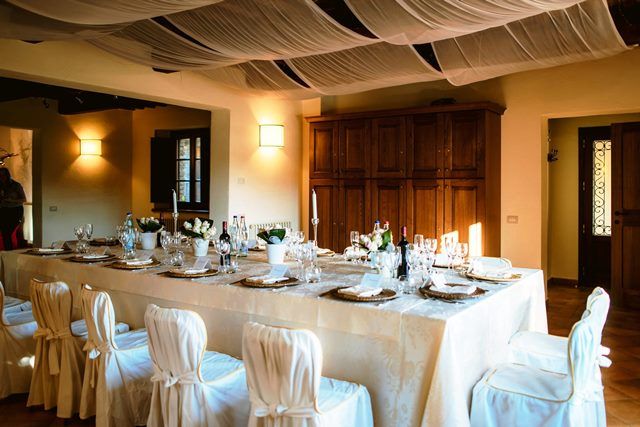 Refined setting for dinners and parties, featuring a large set table and simple decorations.