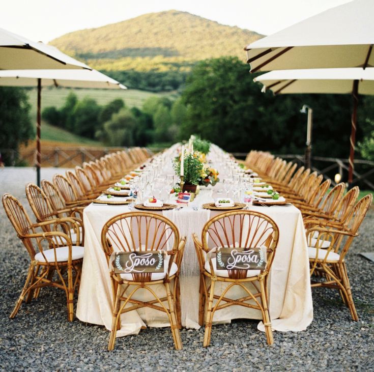 A serene setting for an outdoor lunch, surrounded by lush green hills.