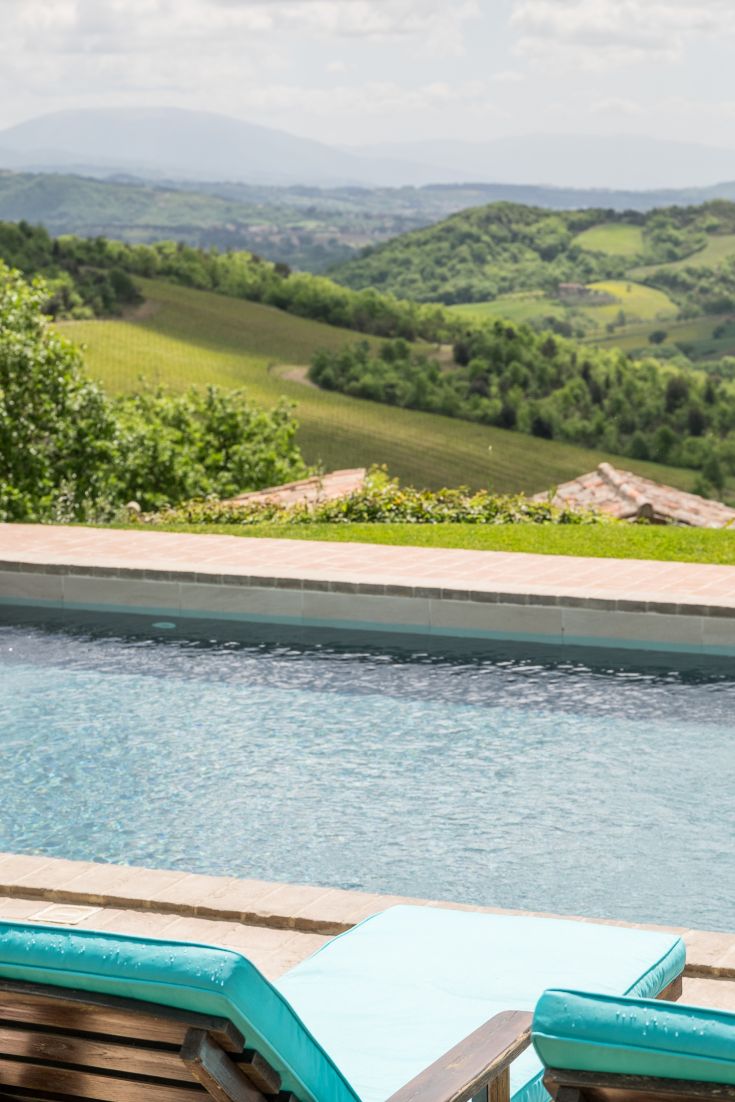 A peaceful scene from a sunbed by the pool, surrounded by typical Umbrian vegetation.