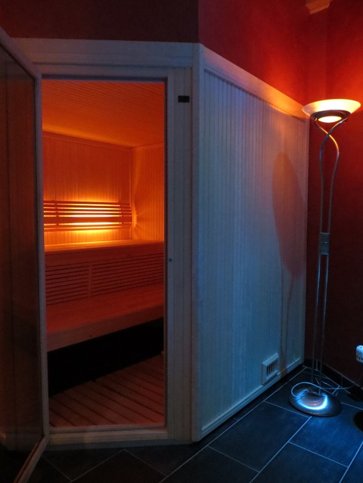 Inside a sauna featuring light wood and warm lighting. A peaceful environment for relaxation.