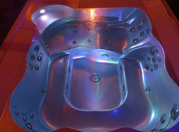 A Jacuzzi hot tub surrounded by soft lights in a spa environment, perfect for relaxing moments.