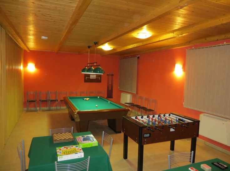 A recreational area featuring a pool table and foosball, ideal for enjoyable moments with friends.