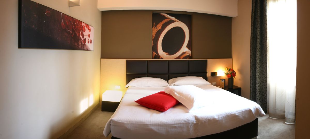 Cozy hotel room with a double bed, simple furnishings, and adequate comfort.