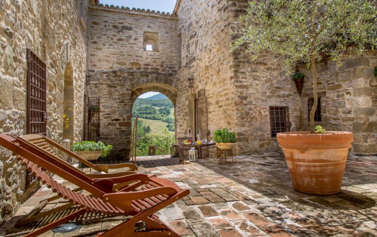 A peaceful, natural setting of an old convent surrounded by typical Umbrian vegetation.