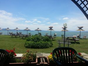 A peaceful corner by Lake Trasimeno, featuring sunbeds and umbrellas for a relaxing moment.