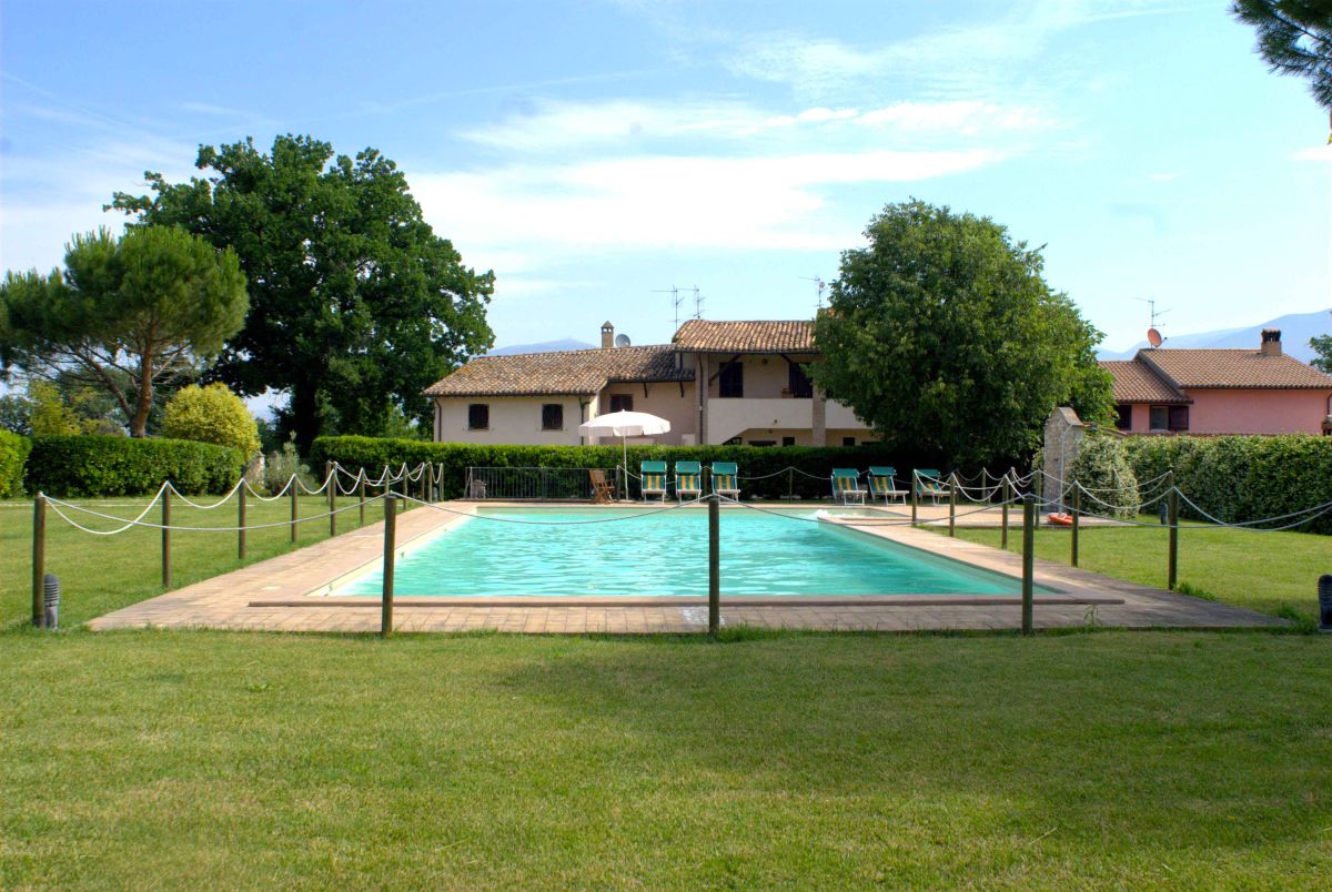 A serene pool nestled in a tranquil garden, surrounded by plants and offering private relaxation spaces.
