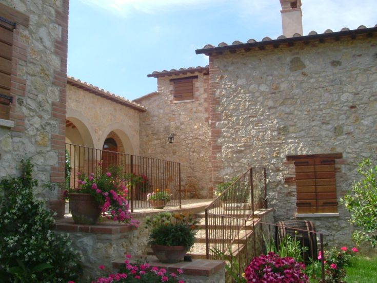 Bâtiment en pierre restauré, entouré par la nature ombrienne, parfait pour une escapade relaxante.