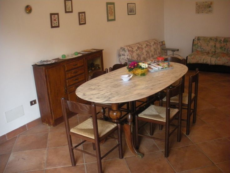 A minimal living room featuring a marble table and appropriate decor.