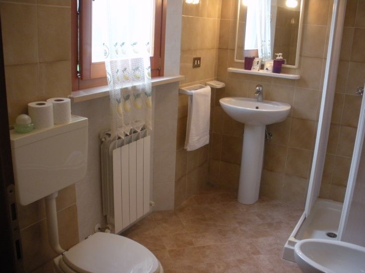 Simple and well-organized bathroom in an agriturismo, perfect for relaxation moments.