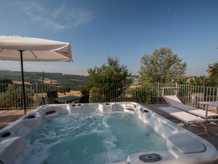 Jacuzzi situated in an environment with a surrounding hilly landscape.