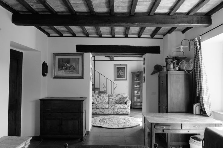 Interior of a building with wooden beams and minimalist rustic style furniture.