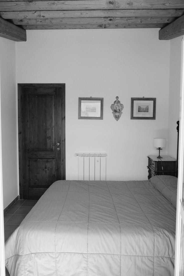 The interior of a bedroom featuring simple furnishings, exuding a relaxing and comfortable atmosphere.