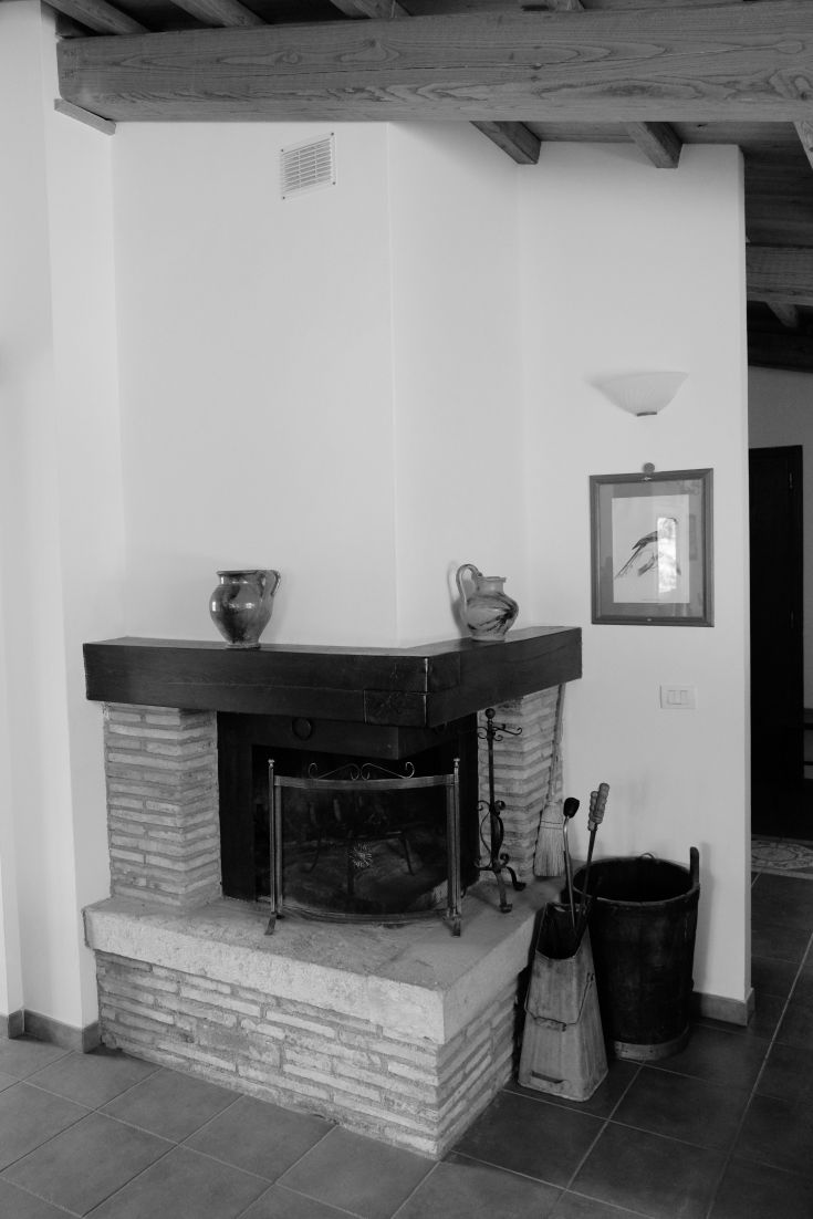 A traditional fireplace in a classic setting with stone elements and elegant decorations.
