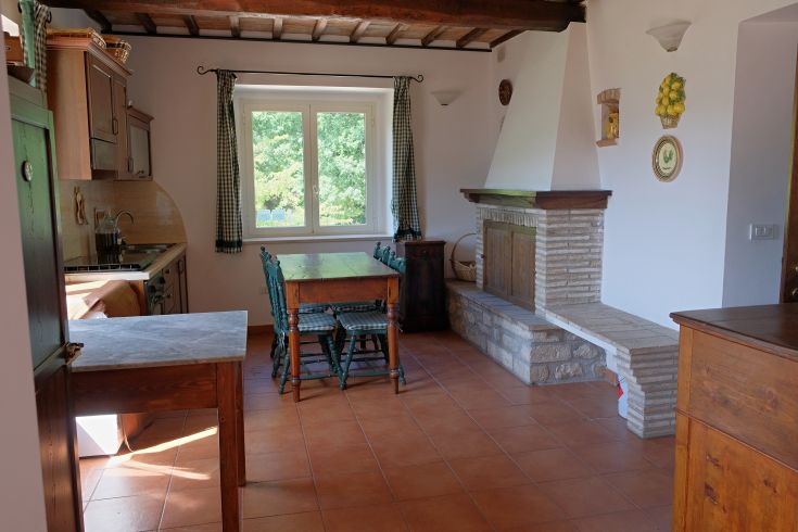 A kitchen with a simple design, featuring a fireplace, perfect for family gatherings.