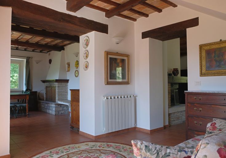 Interiors of a renovated farmhouse, featuring rustic and modern elements, creating a pleasant and cozy environment.