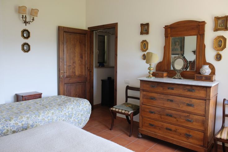 A vintage-style camera in a cozy, warm setting, surrounded by wooden furniture and decorative elements.