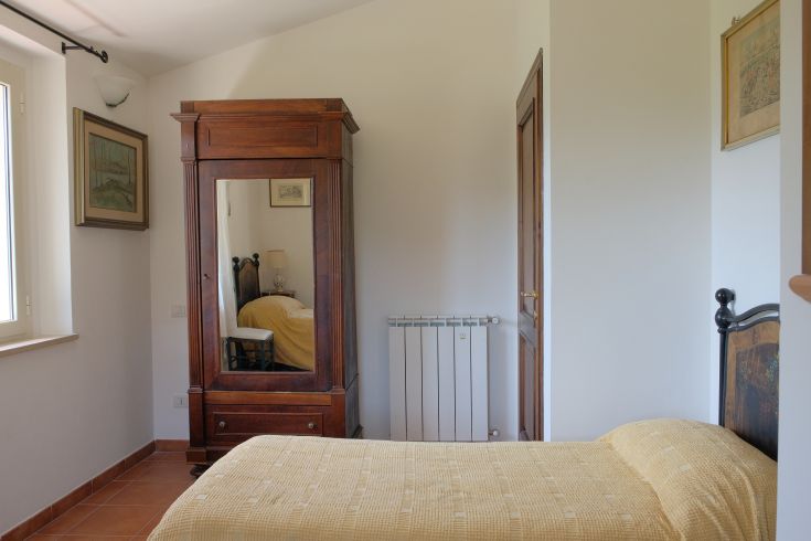 Interior of a rustic farmhouse with wooden furniture and a peaceful view of the surrounding nature.