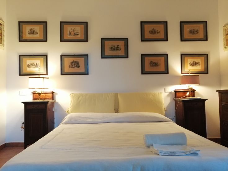 Simple bedroom with double beds and some wall decorations.