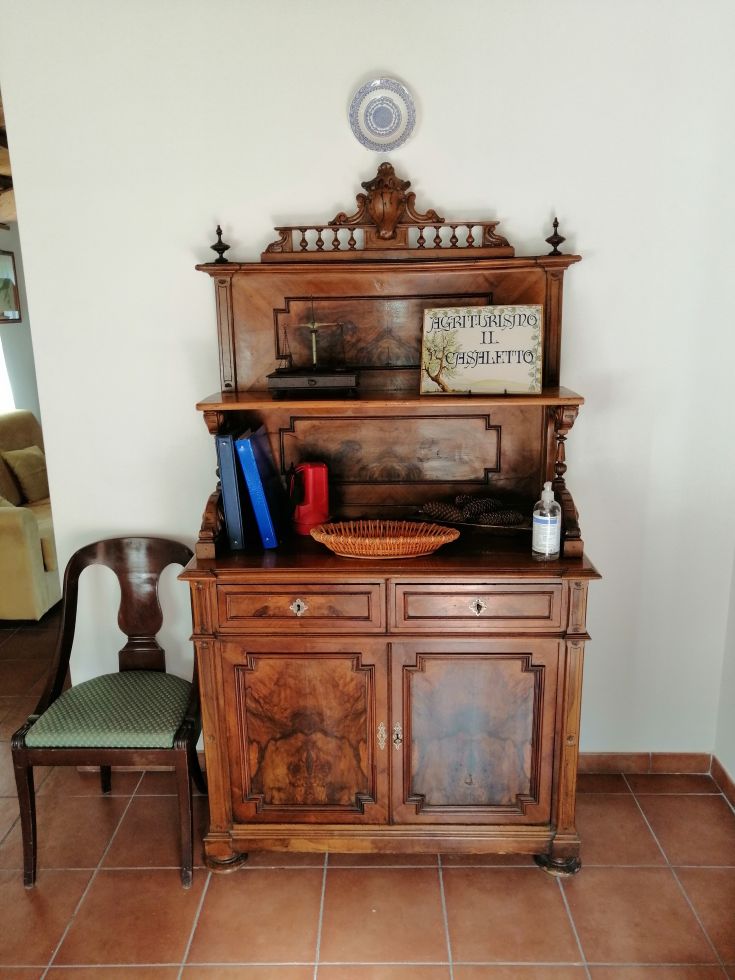 Vintage wooden furniture with simple details and some vintage items on top.