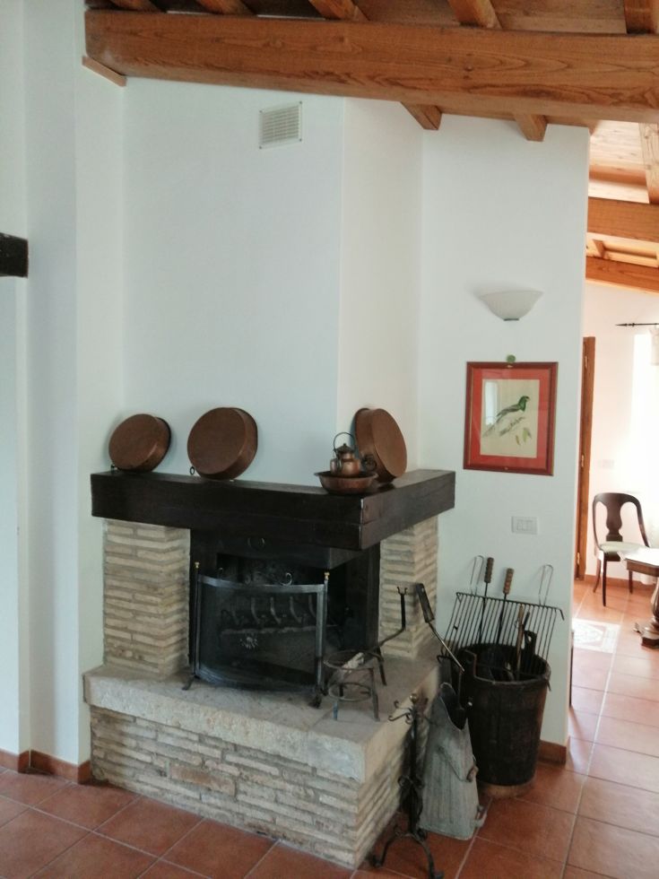 A cozy living room with a stone fireplace and rustic elements, perfect for relaxation.