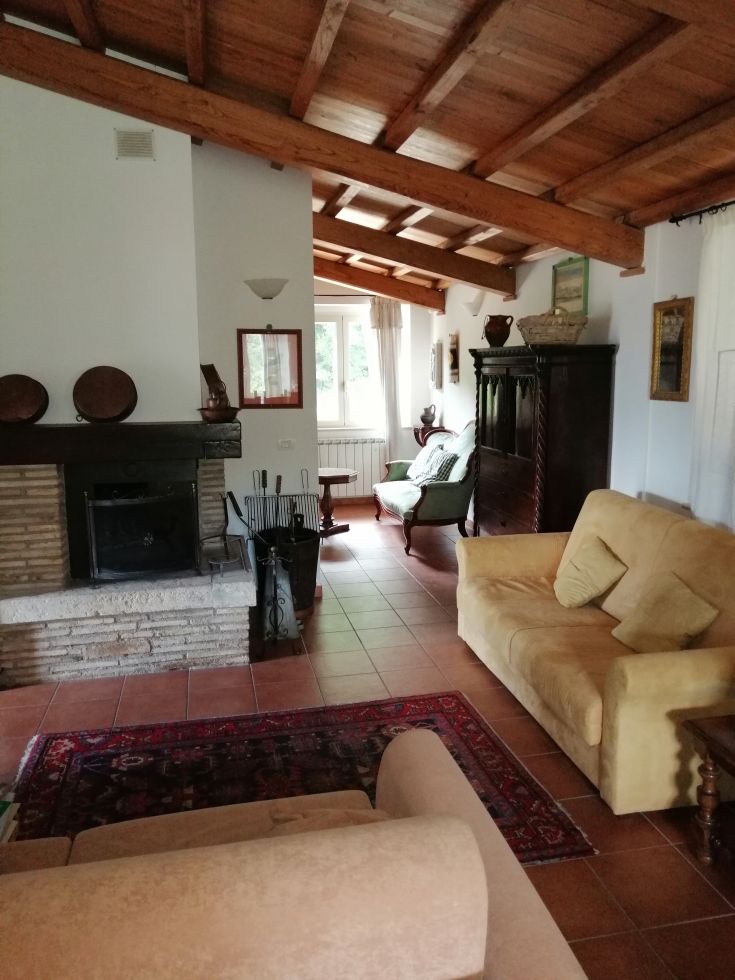 A cozy interior with exposed wooden beams and rustic style furniture, perfect for relaxing moments.