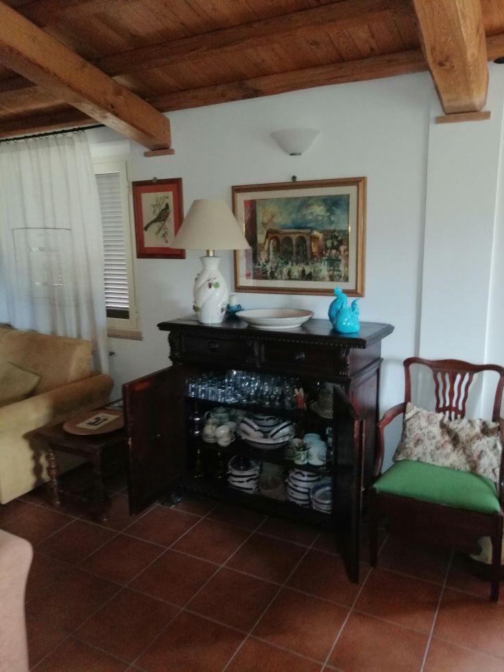 A cozy living room with simple furniture and wooden details, evoking a warm and relaxed atmosphere.