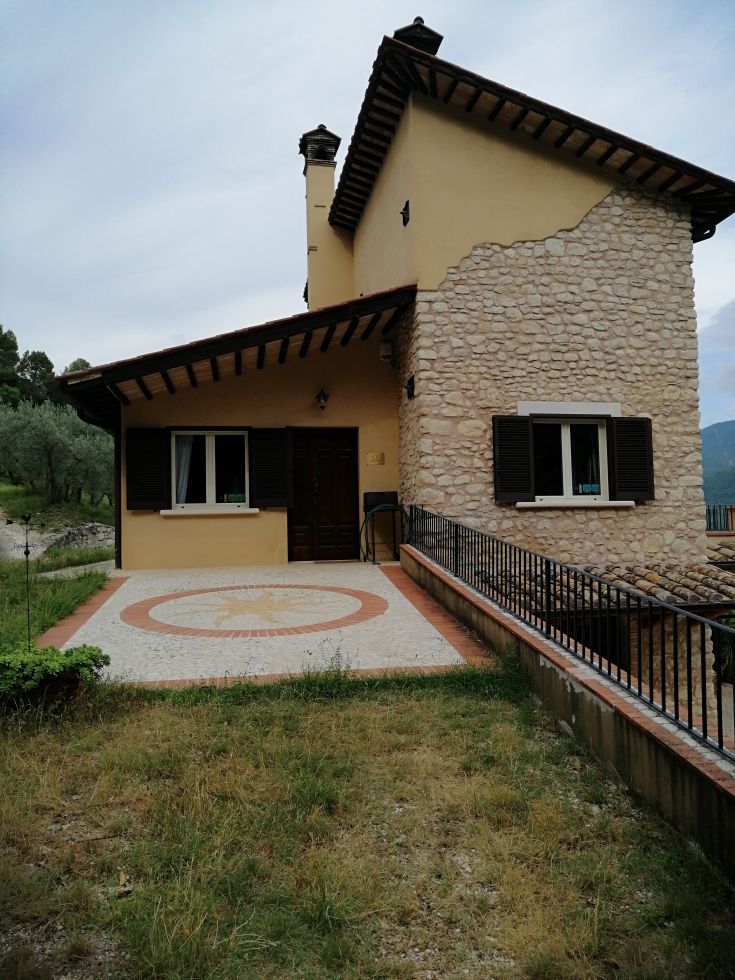 A renovated stone palace surrounded by olive groves in Valnerina, featuring a serene environment and a swimming pool, perfect for nature lovers.