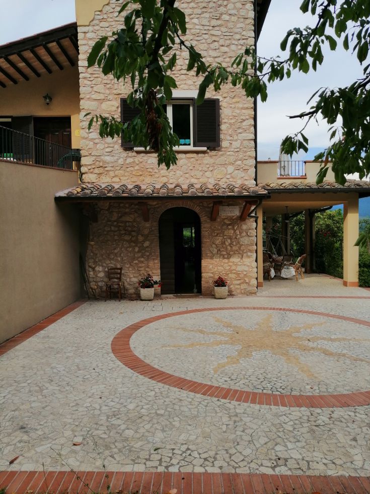 A restored stone farmhouse surrounded by olive trees, featuring a pool. Ideal for those seeking a natural setting.