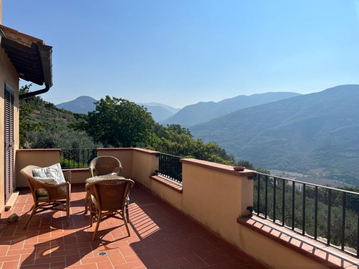 A simple terrace overlooking the surrounding hills, perfect for moments of tranquility.