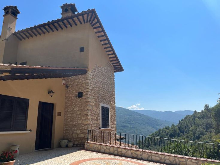 A typical renovated stone farmhouse with a swimming pool, surrounded by olive trees in a quiet area of Valnerina.