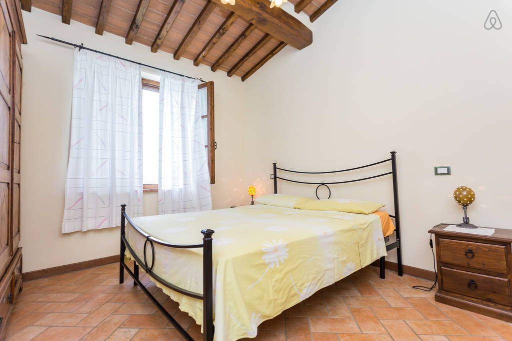 Simple room with basic beds and furnishings, perfect for a peaceful stay.
