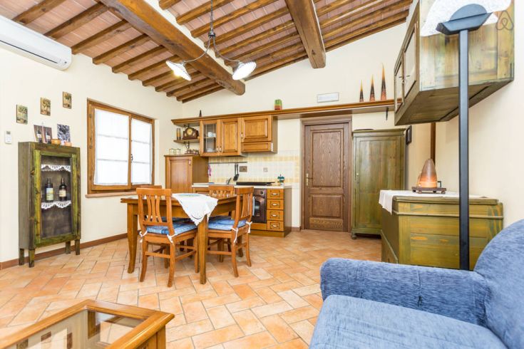 Ein einfacher Wohnraum mit Holz-Küche und rustikalen Möbeln, ideal für ruhige Momente.