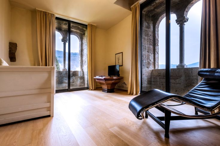 Una stanza semplice e confortevole con vista su un edificio antico, arredamento sobrio e un'atmosfera accogliente.