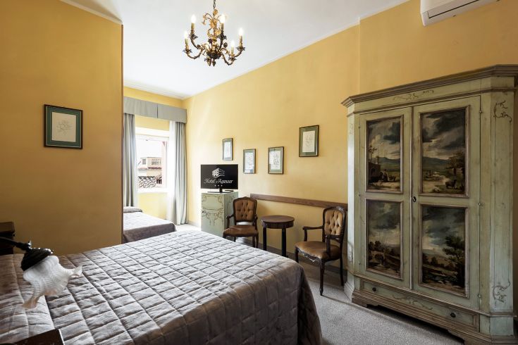 Chambre d'hôtel confortable avec des meubles classiques et vue sur le lac.