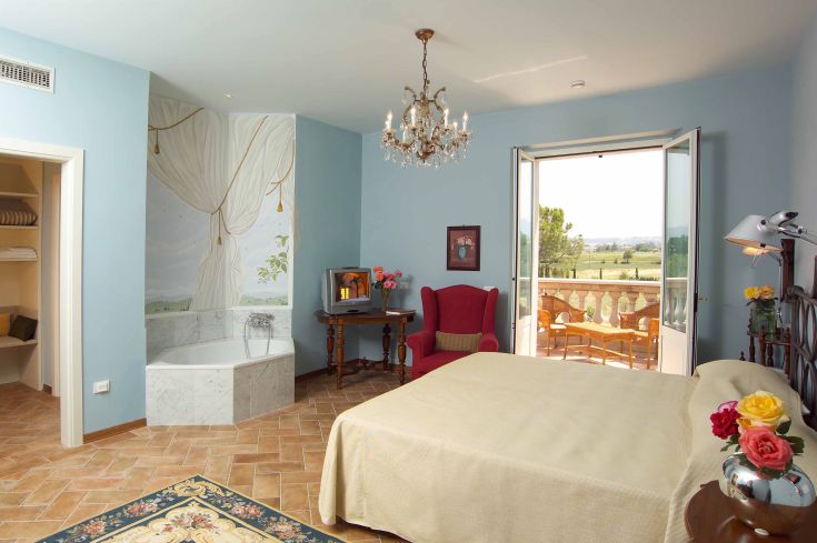 Camera confortevole in una villa umbra, con arredi curati e atmosfera tranquilla, adatta per un soggiorno rilassante.