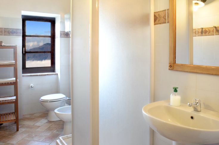 Intérieur de salle de bain lumineux avec douche et lavabo. Éléments simples et fonctionnels.