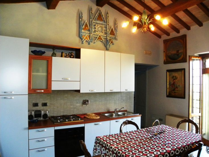 Modern and welcoming kitchen with traditional decorations and a stunning view.
