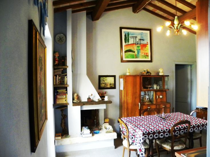 Cozy living room with a fireplace, furnished simply and with attention to detail.