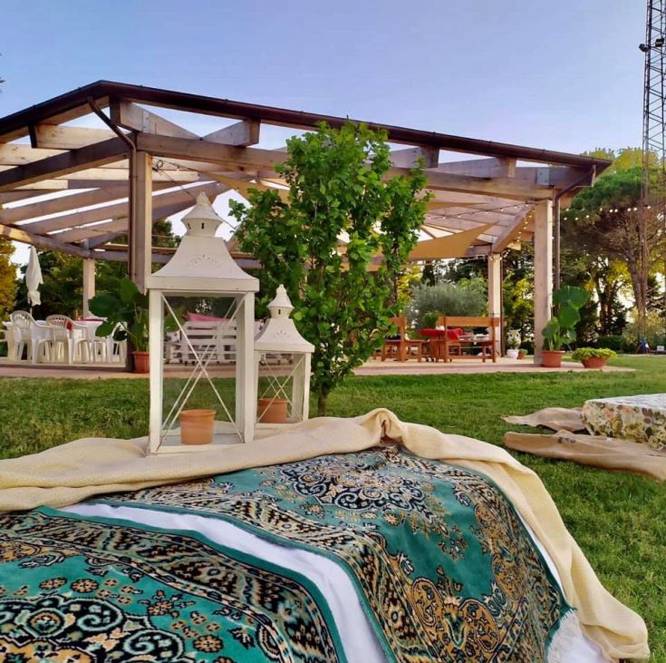 A cozy outdoor area with lanterns and shutters, perfect for relaxing moments outside.