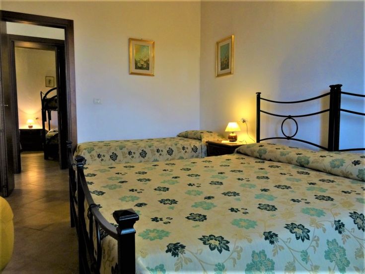 Comfortable room with single beds and minimalist decor creating a relaxed atmosphere.