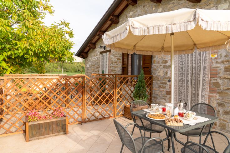 Outdoor space with a table and umbrella, perfect for relaxing outside.