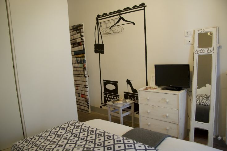 A simple furnished room with a TV area, perfect for relaxation.